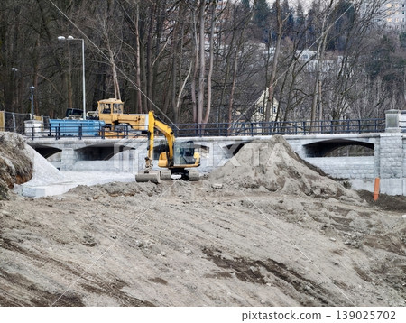 Bulldozer And Excavator Work Together Shifting Granular Material At Bridge Construction Zone 139025702