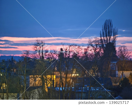 Suburban Dusk With Illuminated Windows. Calm Neighborhood Scene With Twilight And Glowing Interiors 139025717