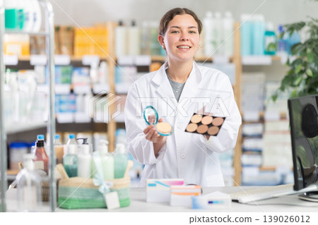 Female pharmacist offering cosmetics Female pharmacist offering cosmetics 139026012