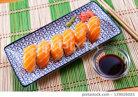 Sushi set of nigiri, served on rectangular plate 139026083