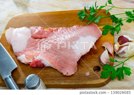 Preparation of raw pork cinch parsley and garlic on wooden board 139026085