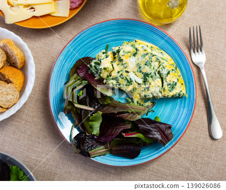 Appetizing breakfast omelette with spinach Appetizing breakfast omelette with spinach 139026086