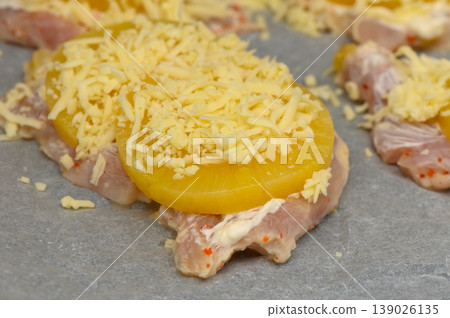 Delicious preparation of chicken topped with pineapple and cheese on a baking 139026135