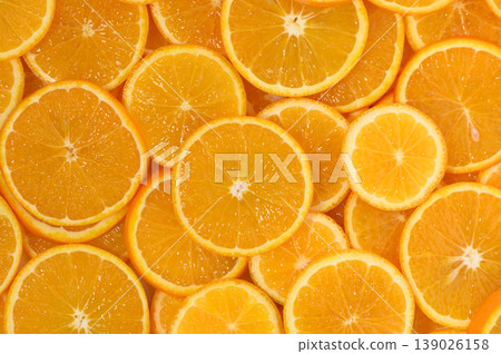 Freshly sliced oranges arranged beautifully on a surface inviting vibrant Freshly sliced oranges arranged beautifully on a surface inviting vibrant 139026158