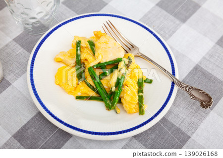 Hearty breakfast is served on plate - omelette and chicken breast, complemented by asparagus. Hearty breakfast is served on plate - omelette and chicken breast, complemented by asparagus. 139026168