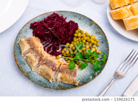Herring fish with canned green peas and beetroot cabbage on plate Herring fish with canned green peas and beetroot cabbage on plate 139026175