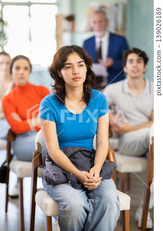 Mature male lecturer in background of classroom, address to young students. Mature male lecturer in background of classroom, address to young students. 139026189