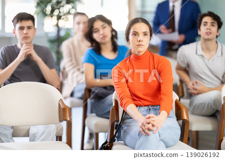 Mature male lecturer in background of classroom, address to young students. Mature male lecturer in background of classroom, address to young students. 139026192