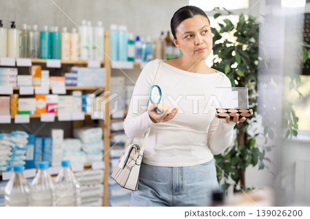 Female customer choosing cosmetics for daily makeup in store Female customer choosing cosmetics for daily makeup in store 139026200