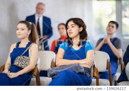 Filipina woman sits at a construction course against the background of other students Filipina woman sits at a construction course against the background of other students 139026217