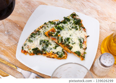 Tasty pizza with tender greens of spinach and cheese Tasty pizza with tender greens of spinach and cheese 139026299
