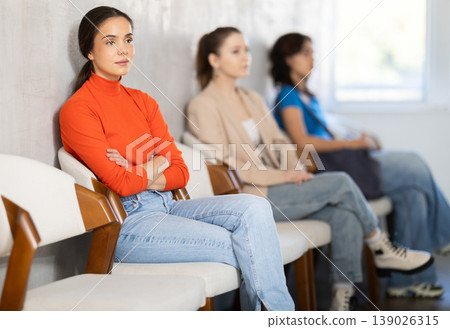 woman sits in line to sign up in school driving courses woman sits in line to sign up in school driving courses 139026315