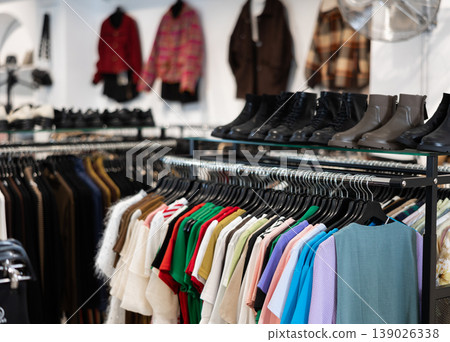 Colorful array of female clothes shoes in shop display, creating vibrant window in clothing store Colorful array of female clothes shoes in shop display, creating vibrant window in clothing store 139026338