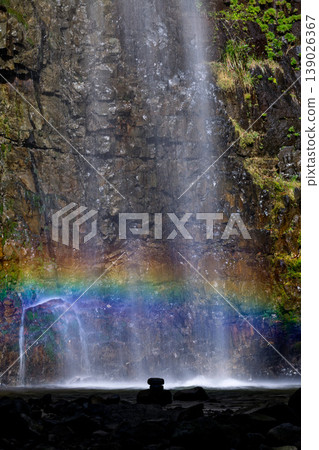 A waterfall with a rainbow, vertical orientation 139026367