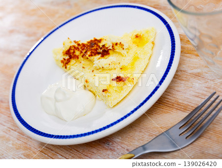 Delicious cottage cheese casserole with sour cream close up 139026420