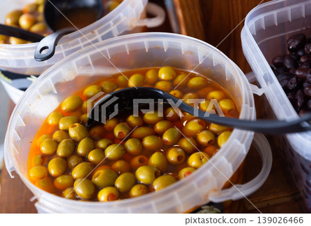 In shop window is bucket filled with salted pickled olives, stuffed shrimp, paprika. In shop window is bucket filled with salted pickled olives, stuffed shrimp, paprika. 139026466