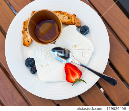 Mato cheese served with honey and berries Mato cheese served with honey and berries 139026496