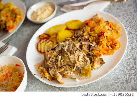 Grilled pork slices with roasted potato and braised cabbage Grilled pork slices with roasted potato and braised cabbage 139026528