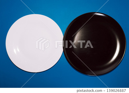 White plate and black plate_blue background White plate and black plate_blue background 139026887