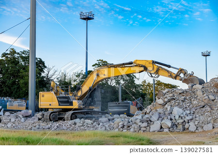 Excavator working on construction site moving rocks heavy machinery industry concept 139027581