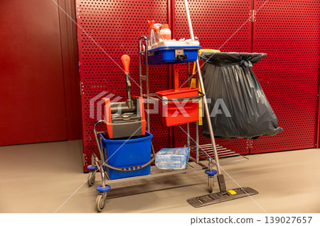 Cleaning cart with supplies and mop indoor maintenance service equipment hygiene concept Cleaning cart with supplies and mop indoor maintenance service equipment hygiene concept 139027657