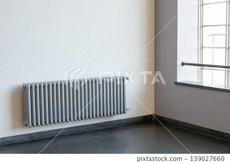Minimal interior room with metal radiator heating system near window natural light copy space Minimal interior room with metal radiator heating system near window natural light copy space 139027660