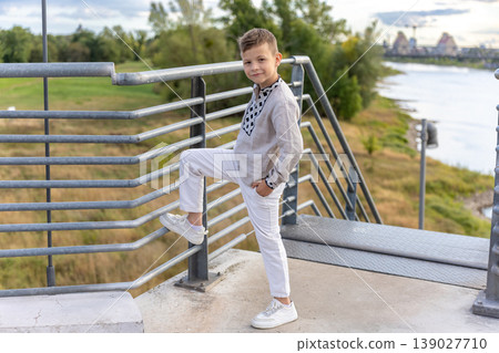 Confident Young Boy Posing On Modern Bridge Riverside Summer Portrait Confident Young Boy Posing On Modern Bridge Riverside Summer Portrait 139027710