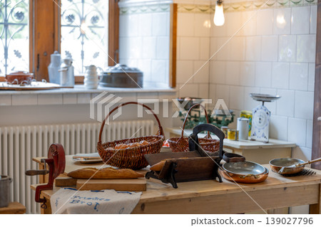 Vintage Kitchen Interior With Wooden Table Bread Basket And Traditional Cooking Tools 139027796