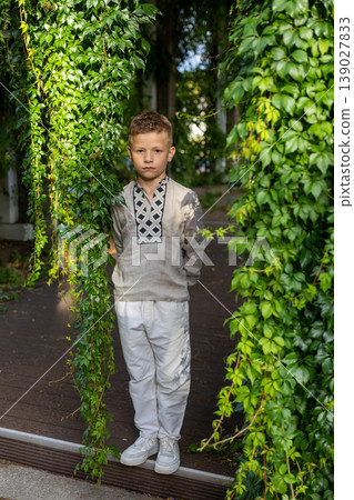 Confident Year Old Boy Standing Between Green Ivy Columns In Summer Garden Portrait Confident Year Old Boy Standing Between Green Ivy Columns In Summer Garden Portrait 139027833