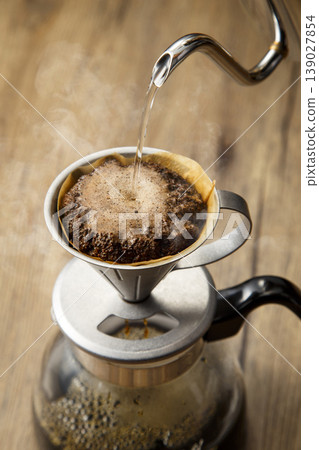The image of brewing coffee using the hand-drip method. The image of brewing coffee using the hand-drip method. 139027854