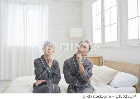 Senior couple thinking in the bedroom Senior couple thinking in the bedroom 139028174