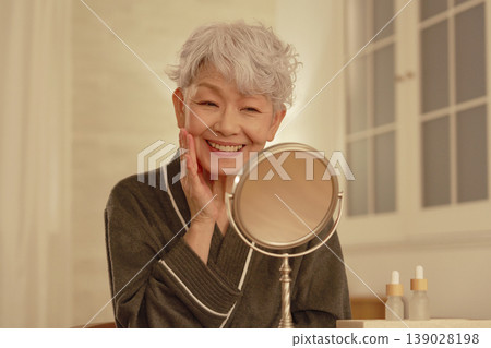 Senior woman's nighttime facial care Senior woman's nighttime facial care 139028198