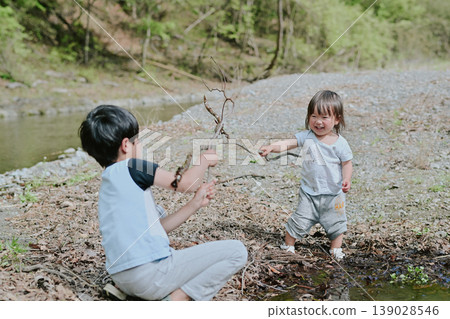 Brothers playing by the river 139028546