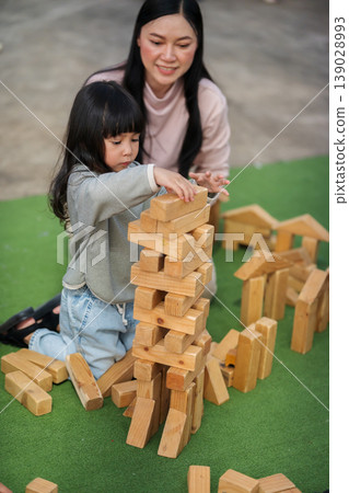 mother and preschool child girl playing with wooden toy block at outdoor mother and preschool child girl playing with wooden toy block at outdoor 139028993