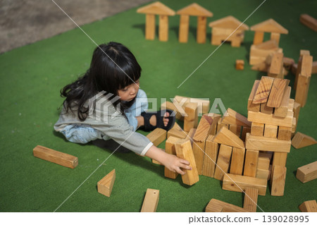 preschool child girl playing with wooden toy block at outdoor preschool child girl playing with wooden toy block at outdoor 139028995