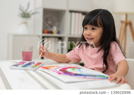 happy preschool child girl painting with watercolor on paper happy preschool child girl painting with watercolor on paper 139028996