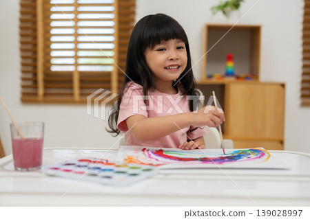 happy preschool child girl painting with watercolor on paper happy preschool child girl painting with watercolor on paper 139028997