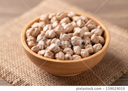 Organic raw chickpeas in a wooden bowl, healthy food ingredient 139029010