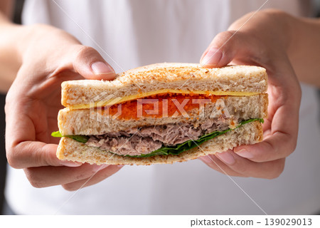 Healthy toasted whole wheat sandwich with tuna, Ebiko (Capelin roe), cheese, and fresh lettuce  139029013