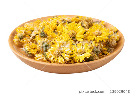 Dried Chrysanthemum flower tea in wooden bowl isolated on white background Dried Chrysanthemum flower tea in wooden bowl isolated on white background 139029048