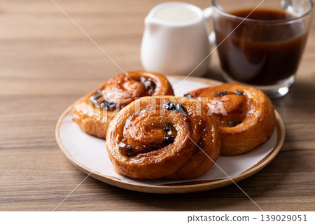 French Pain au Raisin, Cinnamon Raisin Swirl and hot coffee, Delicious breakfast French Pain au Raisin, Cinnamon Raisin Swirl and hot coffee, Delicious breakfast 139029051