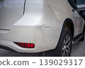 White SUV with visible rear bumper scratch and damage close up 139029317