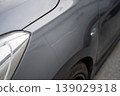 Close-up of Gray Car with Scratch on Side Panel Near Headlight 139029318
