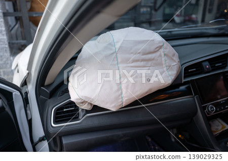 Deployed Passenger Airbag Inside Car Interior After Collision Deployed Passenger Airbag Inside Car Interior After Collision 139029325