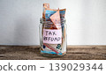 Tax Refund Savings Concept With Cash Money Stored in Glass Jar 139029344