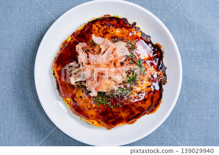 Okonomiyaki: Kansai-style okonomiyaki topped with bonito flakes and sauce. Okonomiyaki: Kansai-style okonomiyaki topped with bonito flakes and sauce. 139029940