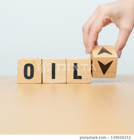 Hand change wooden block with OIL text to UP and Down arrow symbol icon. Trade war, stocks, financial, cut loss and economic concept 139030252