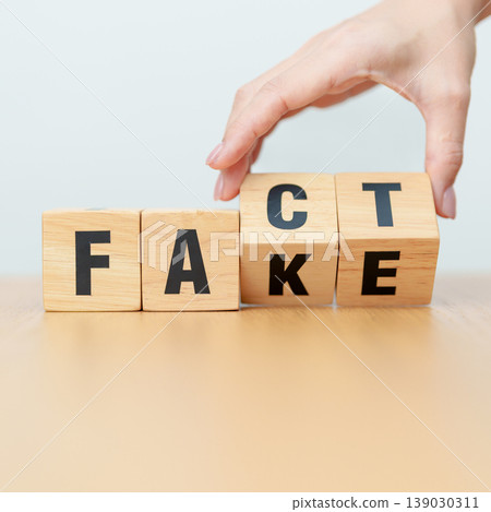 hand change wooden block FAKE to FACT. rumor News, false, myth, evidence and disinformation concepts 139030311