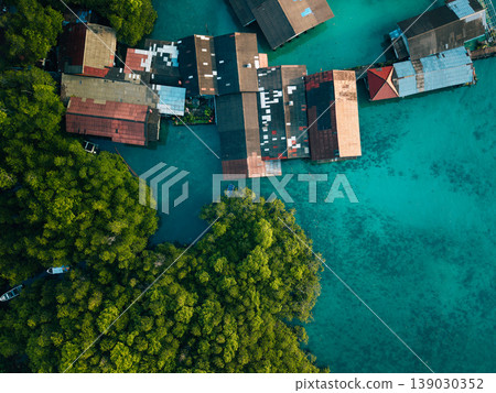 Aerial view of a traditional coastal village living in harmony with nature, showcasing sustainable living and slow life. Aerial view of a traditional coastal village living in harmony with nature, showcasing sustainable living and slow life. 139030352