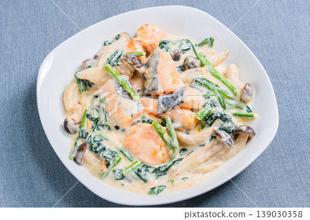 Creamy salmon and spinach dish with mushrooms in a rich white sauce. 139030358